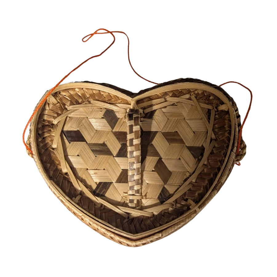 Heart-shaped woven basket on a white background