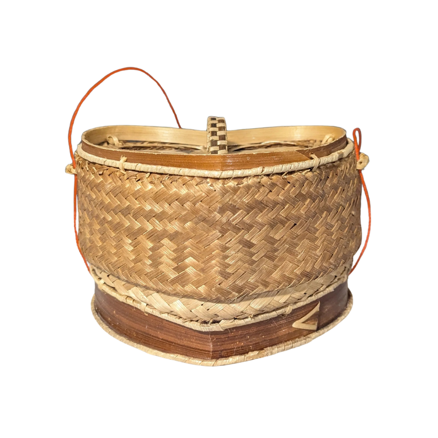 Woven rice basket with a handle on a white background