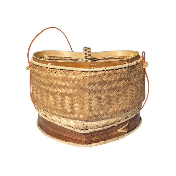 Woven rice basket with a handle on a white background