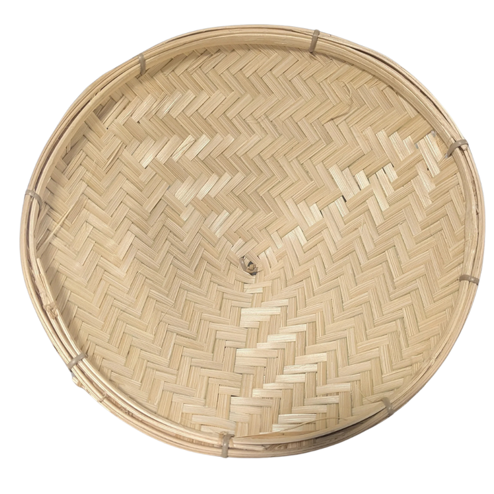 Round woven bamboo basket on a white background