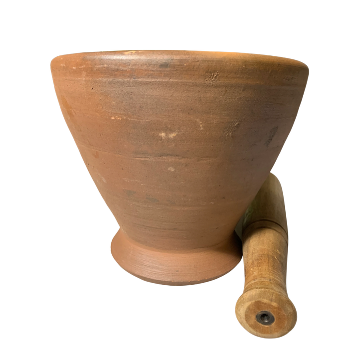 Terracotta mortar and pestle on a white background