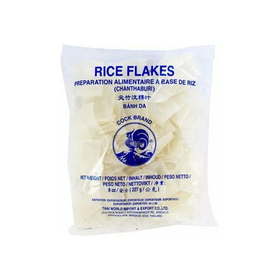 Clear package of Cock Brand square rice flakes with navy blue fonts and logo. 
