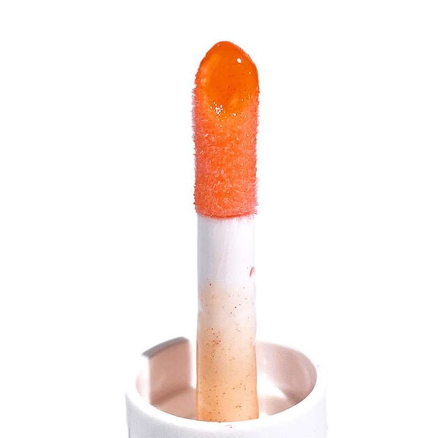 Lipstick with orange top and white bottom on a white background