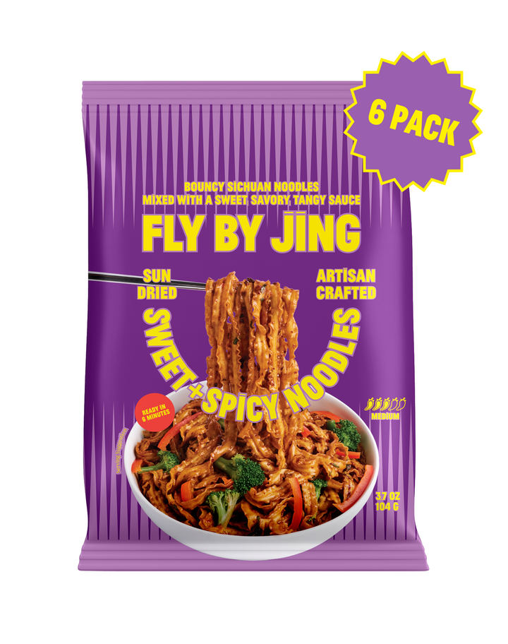 A purple bag of Fly By Jing Sweet Spicy Noodles, 3.7 oz, featuring a bowl of noodles on the front, a yellow &