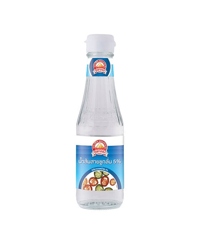 A small clear glass bottle of Golden Mountain Distilled Vinegar with a sky blue label featuring an image of colorful sliced Thai chili peppers in a small bowl of vinegar. 