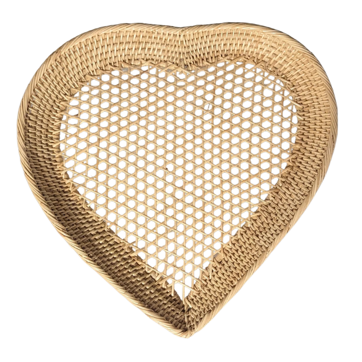 Heart-shaped bamboo woven plate on a white background