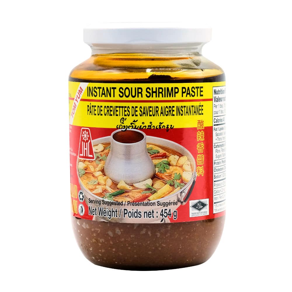 A 16oz glass jar of instant sour shrimp paste with a colorful red and yellow label with an image of steel hotpot image with surrounding vegetables.