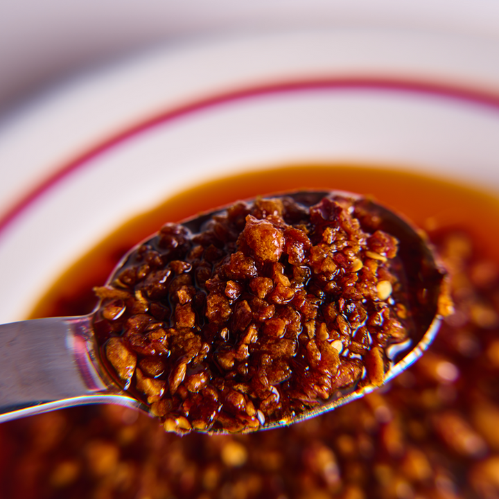 Spoonful of dark brown paste with a blurred background