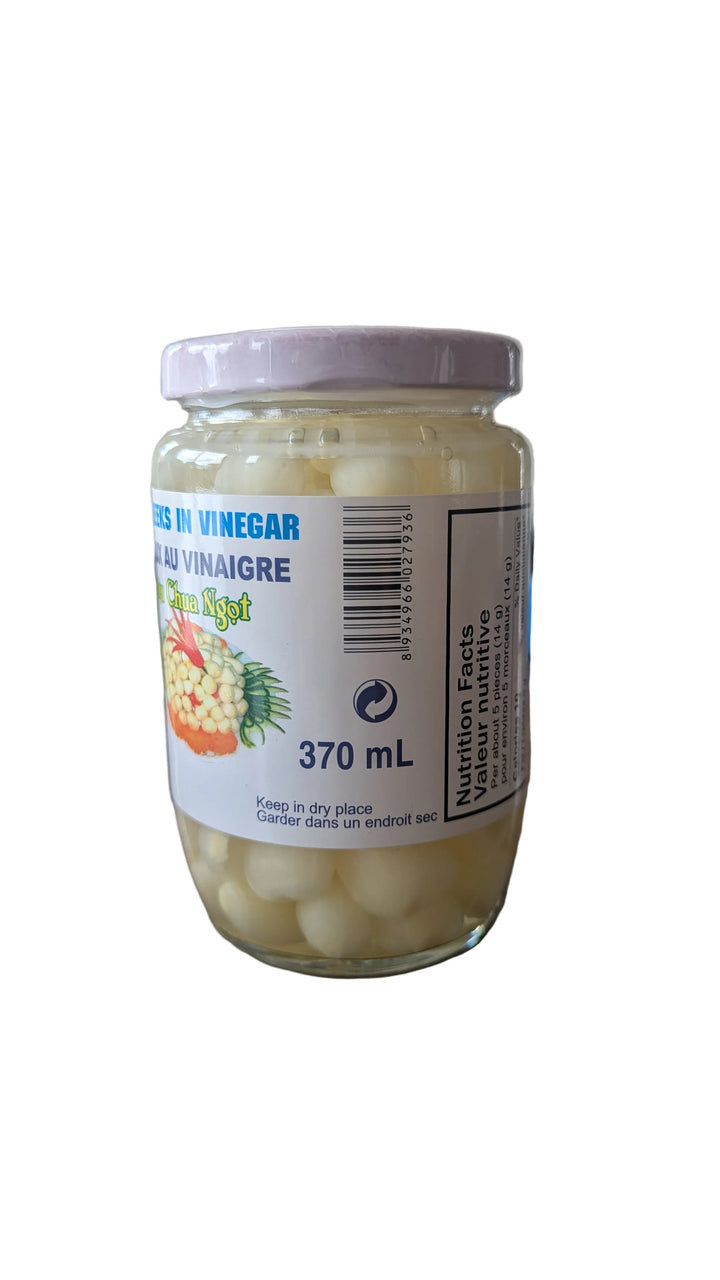 Jar of pickles with a label on a wooden surface