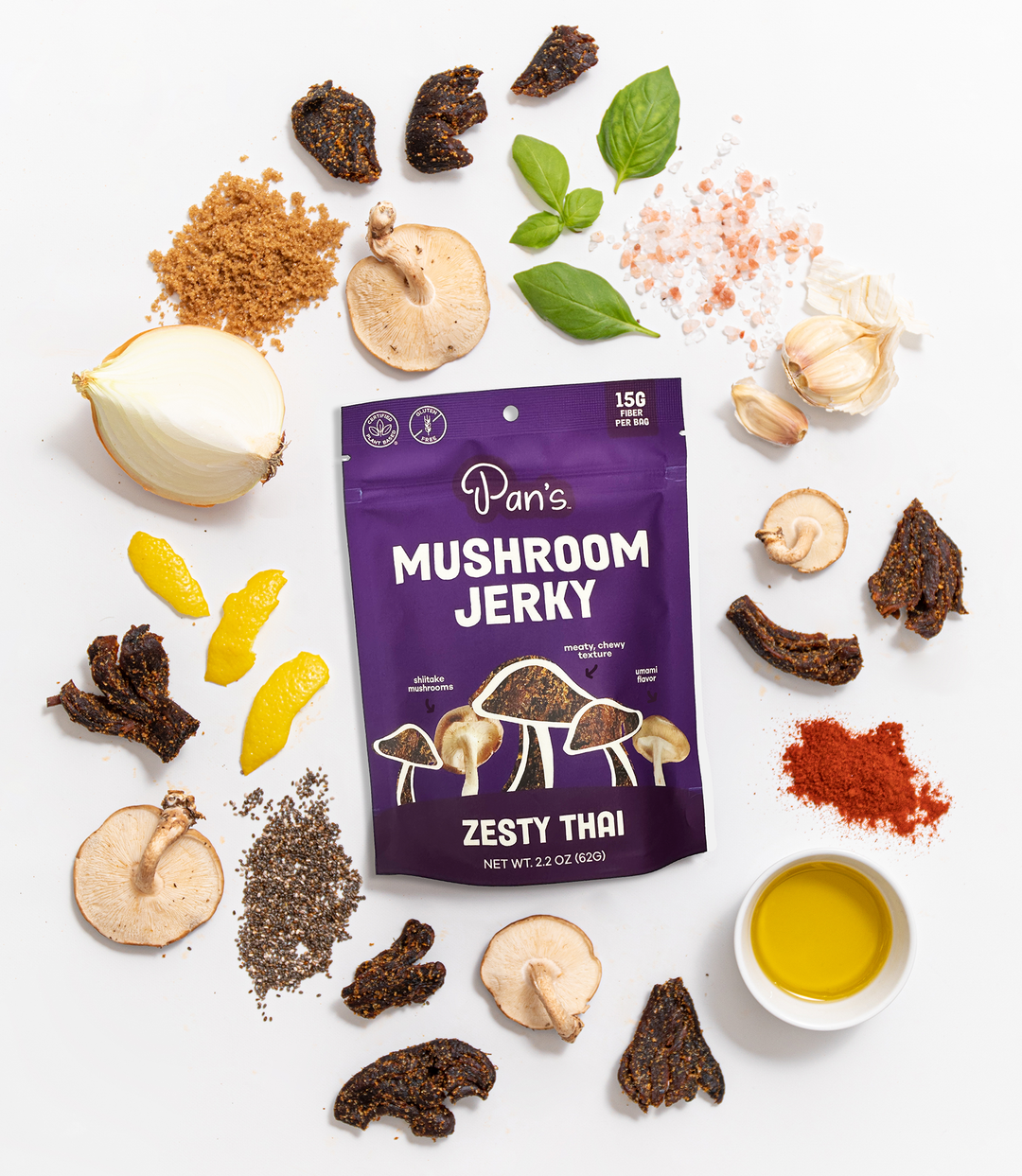 Pan's Mushroom Jerky Zesty Thai package surrounded by ingredients on a white background