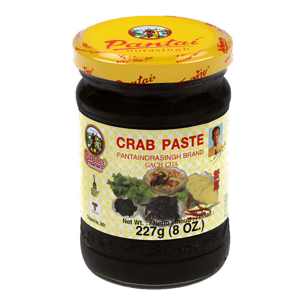 Jar of Pantai Norasingh brand fermented crab paste, 8 oz (227g), with a yellow lid and labeled in English and Thai.