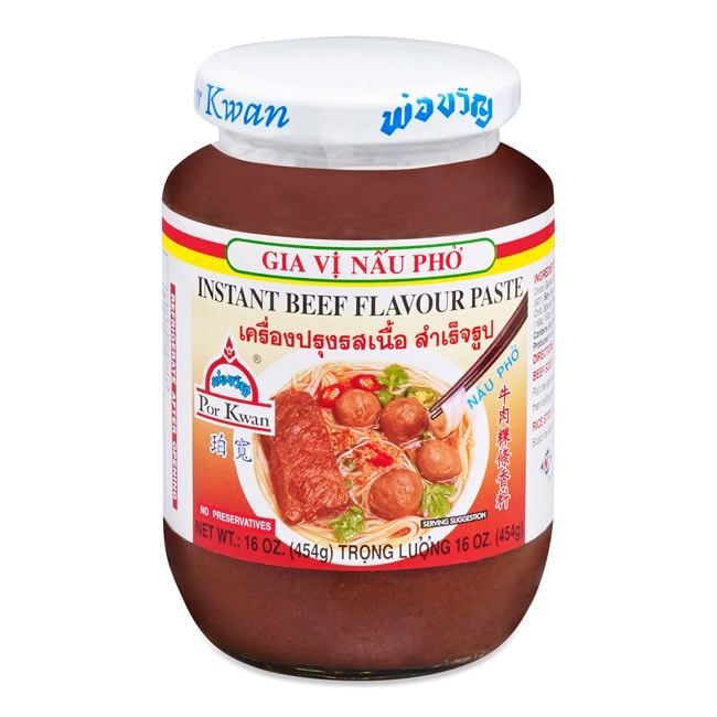 A glass jar of Por Kwan Instant Beef Flavor Paste, with an image of white bowl with meatballs, diced red Thai chilis, sprinkled cilantro and noodles on the label.