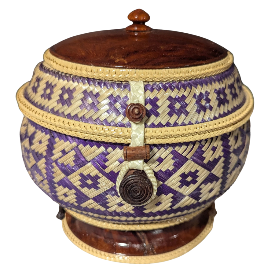 Woven basket with purple and beige patterns and wooden accents on a white background