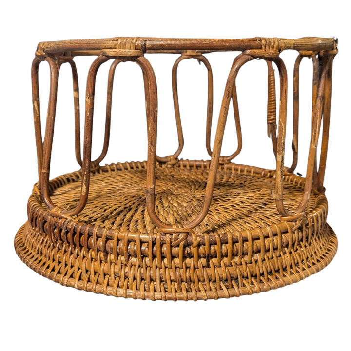 Upside down side view of brown woven bamboo rattan table on a white background