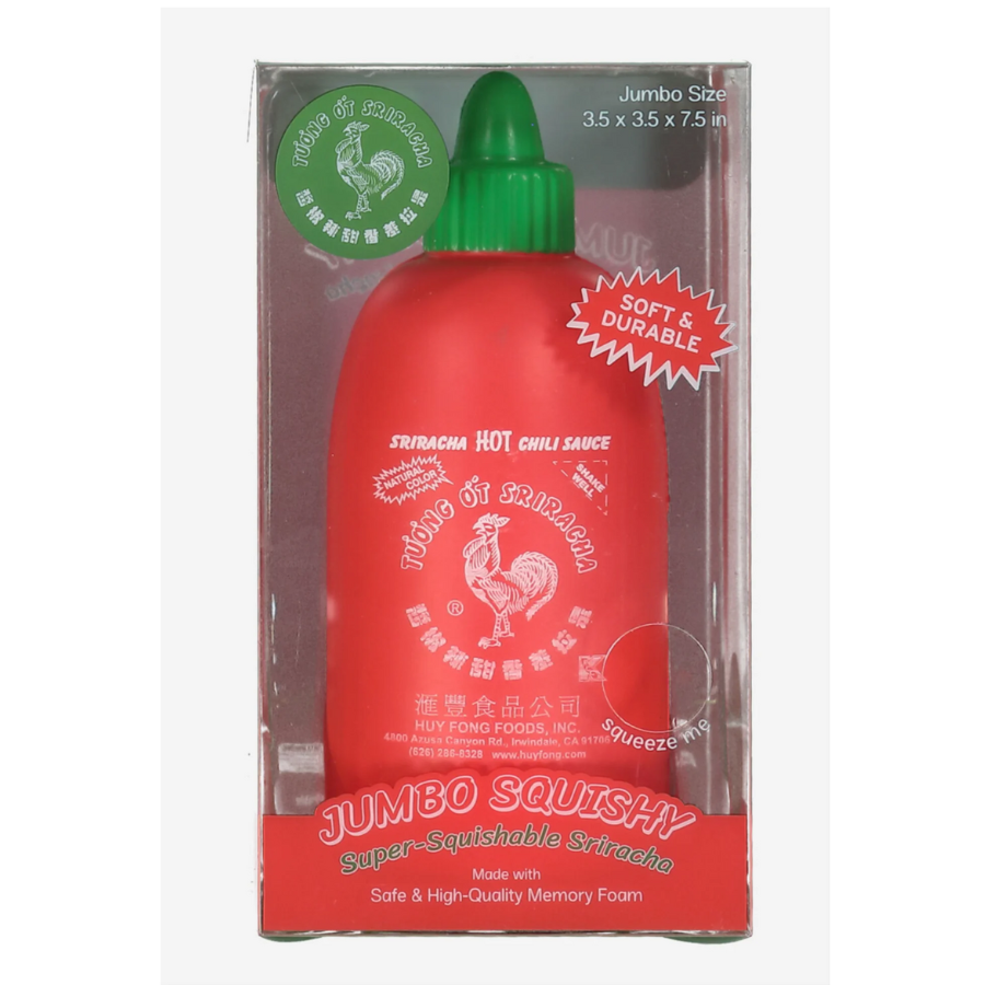 Red squishy bottle with green cap in packaging on a white background