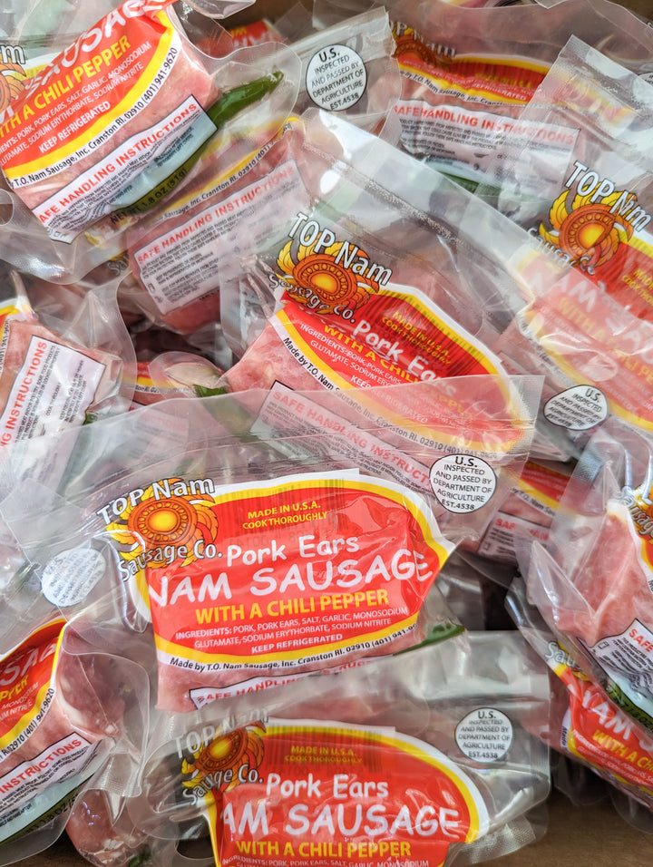 Multiple Top Nam Brand Pork Ears Nam Sausage with chili pepper, vacuum-sealed. Made in the USA, USDA inspected, refrigerated, and ready to cook.