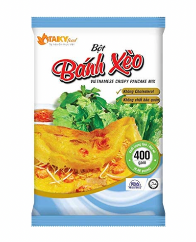 Plastic bag packaging of Vietnamese crispy pancake mix with a yellow omelette and green vegetables on a white background.