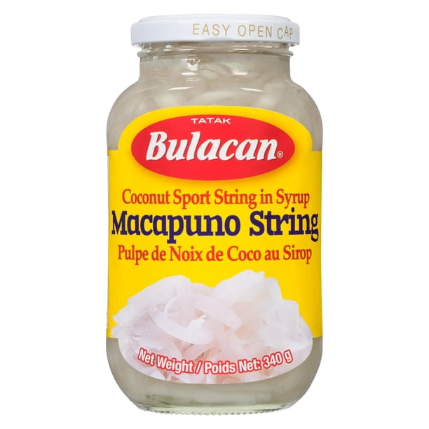 A glass jar of Tatak Bulacan Macapuno String (Coconut Sport String in Syrup) on a plain white background. The jar has a yellow label with a red Tatak Bulacan logo and a white cap.