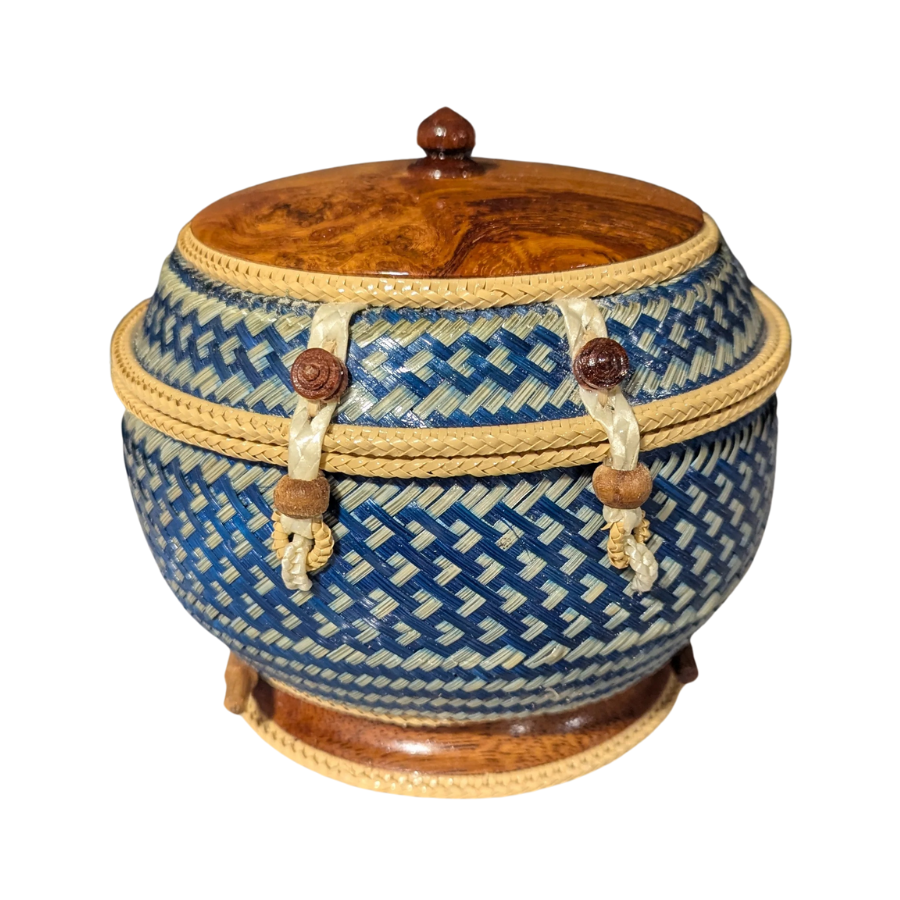 Decorative woven basket with a wooden lid on a white background