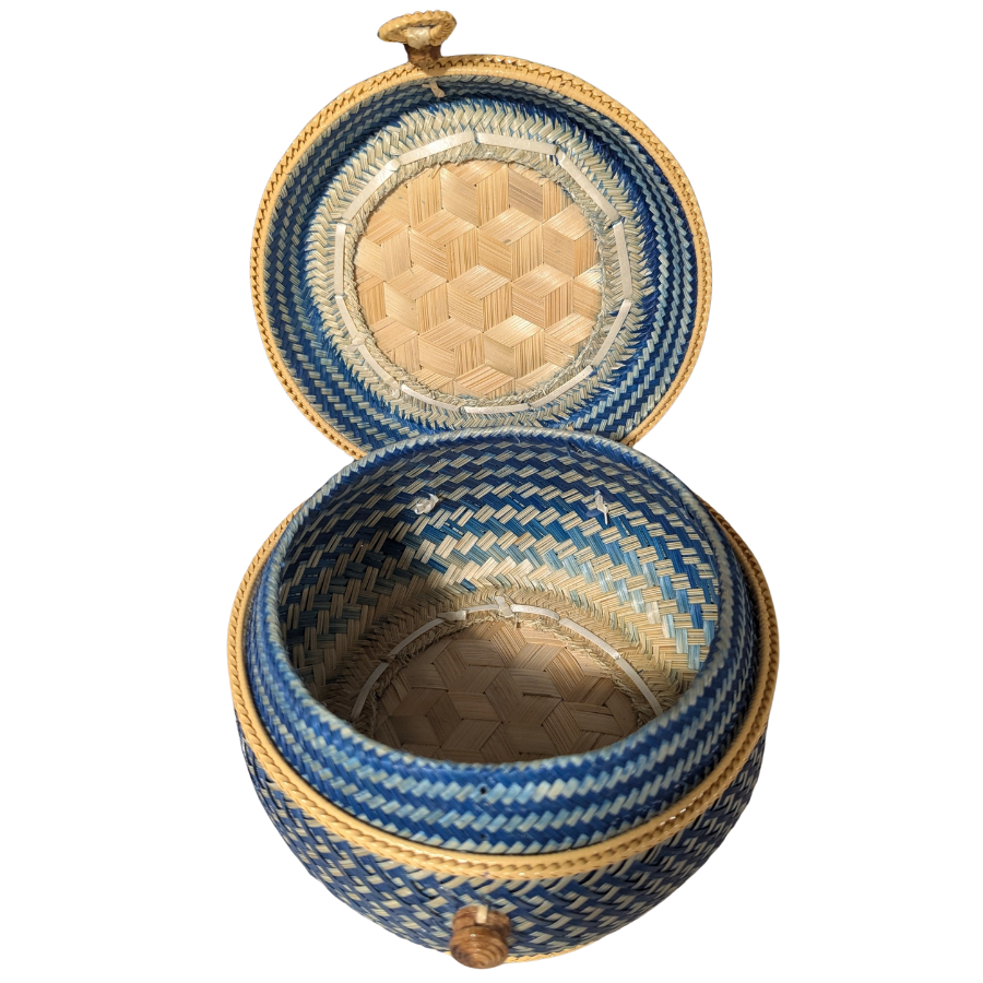 Blue and gold woven basket with lid on a white background