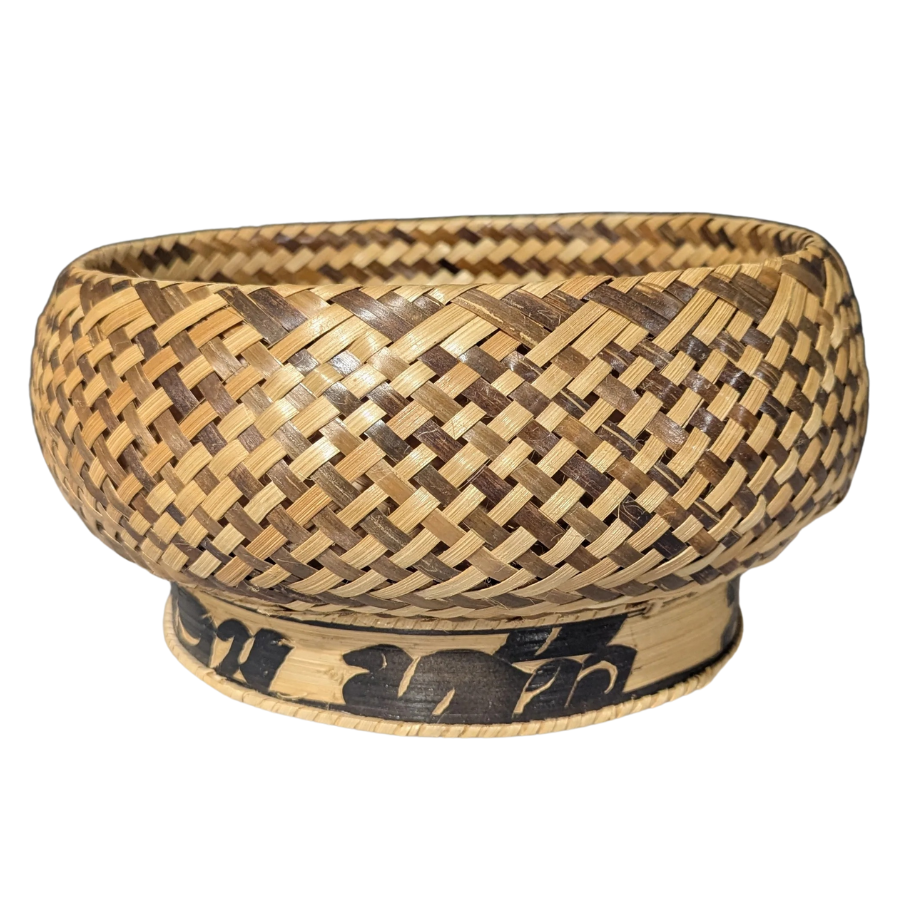 Woven bamboo bowl with decorative elements on a white background