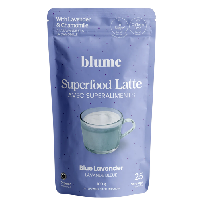 A 100g stand-up pouch of Blume Superfood Latte in Blue Lavender flavor, featuring a light purple-blue background with white text and a graphic of a glass cup of latte.