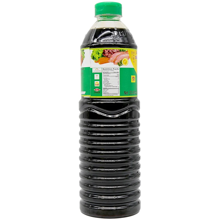 Bottle of soy sauce with a green cap on a white background