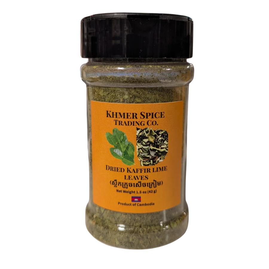 A jar of Khmer Spice Trading Co. Dried Kaffir Lime Leaves, featuring a bright orange label and a black lid, set against a plain white background.
