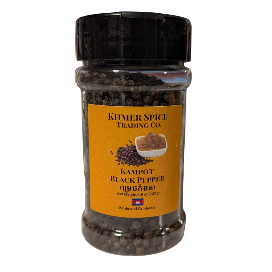 A clear plastic spice jar filled with black peppercorns, featuring a black screw cap and a yellow-orange label that reads &