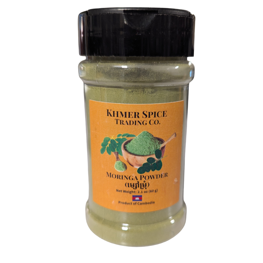 A clear plastic spice jar filled with green moringa powder, featuring a black screw cap and an orange label that reads 'KHMER SPICE TRADING CO. MORINGA POWDER'.