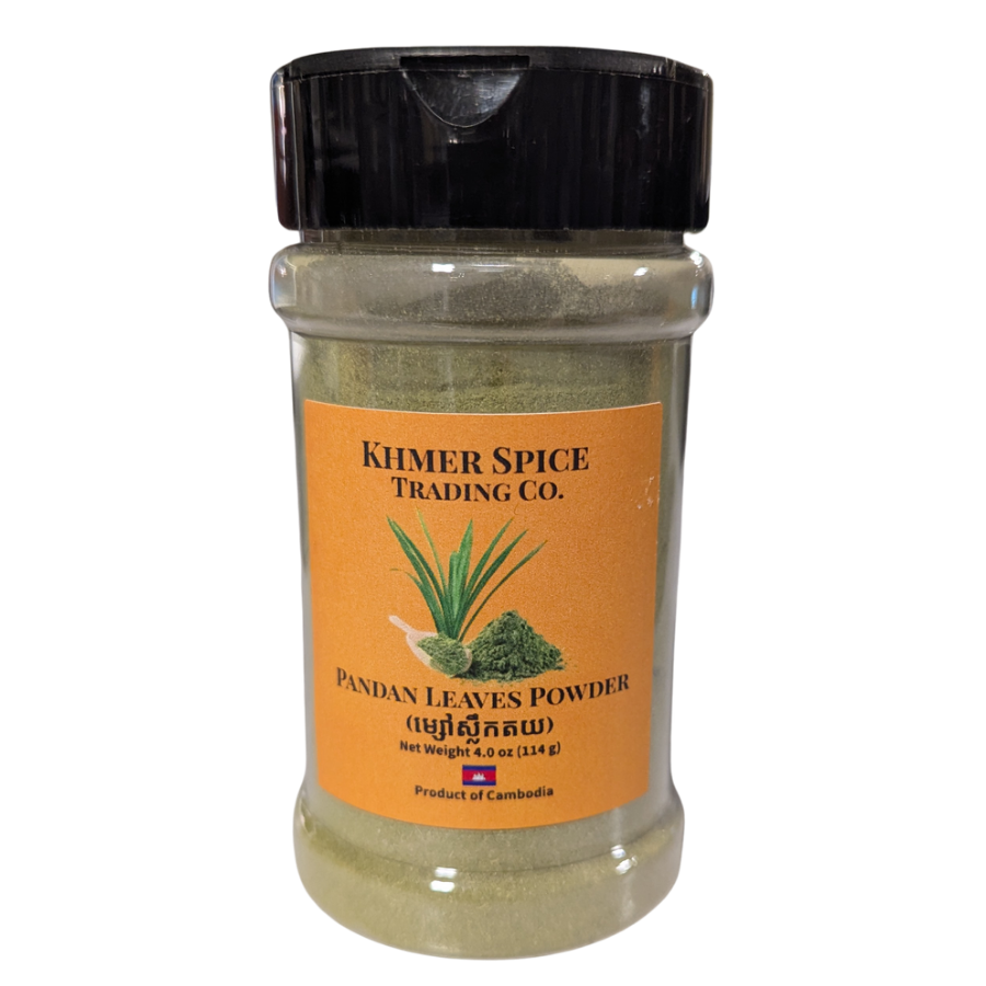 A clear plastic spice jar containing greenish-brown pandan leaves powder, featuring a bright orange label with the brand name 'Khmer Spice Trading Co.' and a black flip-top lid, set against a plain white background.