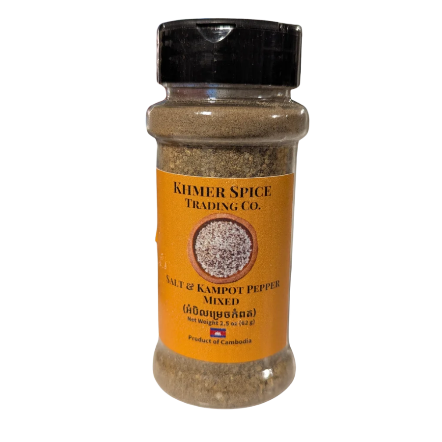 A bottle of Khmer Spice Trading Co. Salt & Kampot Pepper Mixed, featuring a black cap and an orange label, set against a plain white background.