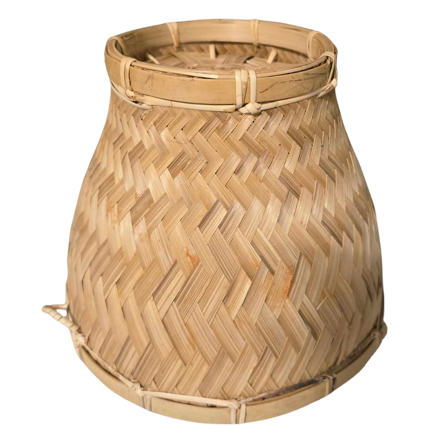 Woven bamboo basket with a herringbone pattern on a white background