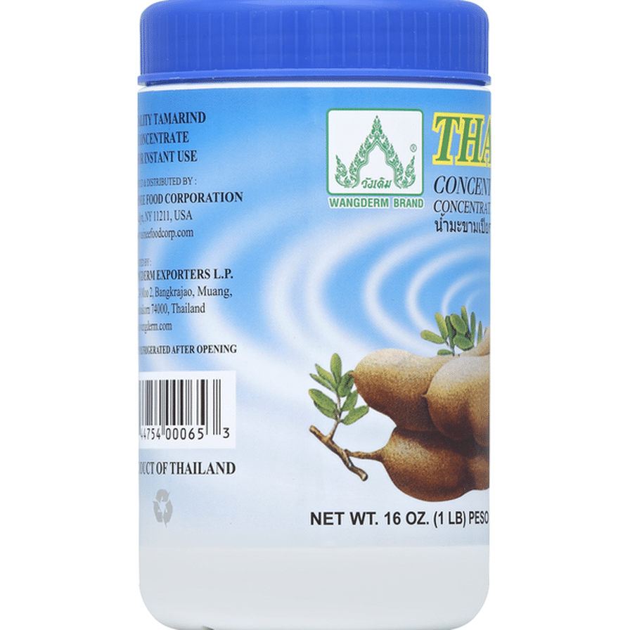 Jar of tamarind concentrate with blue lid and white label on a white background