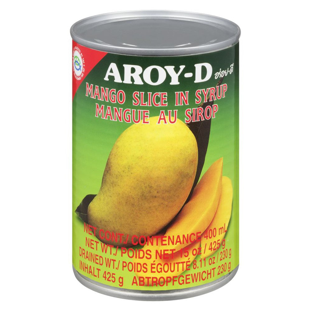 A can of Aroy-D Mango Slices in Syrup with a mango slice and bananas in the background. The can has a green label with yellow text and a mango graphic.