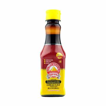 Bottle of Golden Mountain Seasoning Sauce with a green cap and label featuring Thai characters.