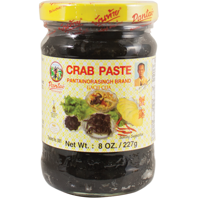 Jar of Pantai Norasingh brand fermented crab paste, 8 oz (227g), with a yellow lid and labeled in English and Thai.
