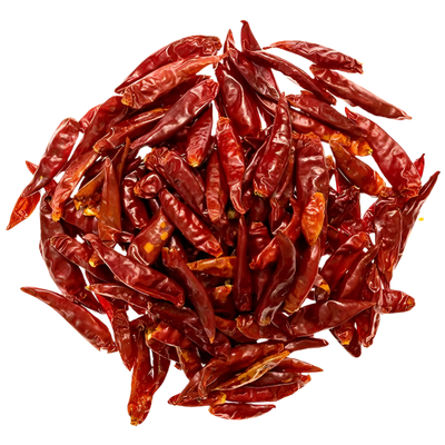 Pile of dried red chili peppers with a glossy texture and scattered seeds on a white background.