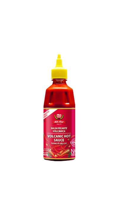 Bottle of Volcanic Hot Sauce with a red label, yellow squeeze cap, and chili pepper graphics