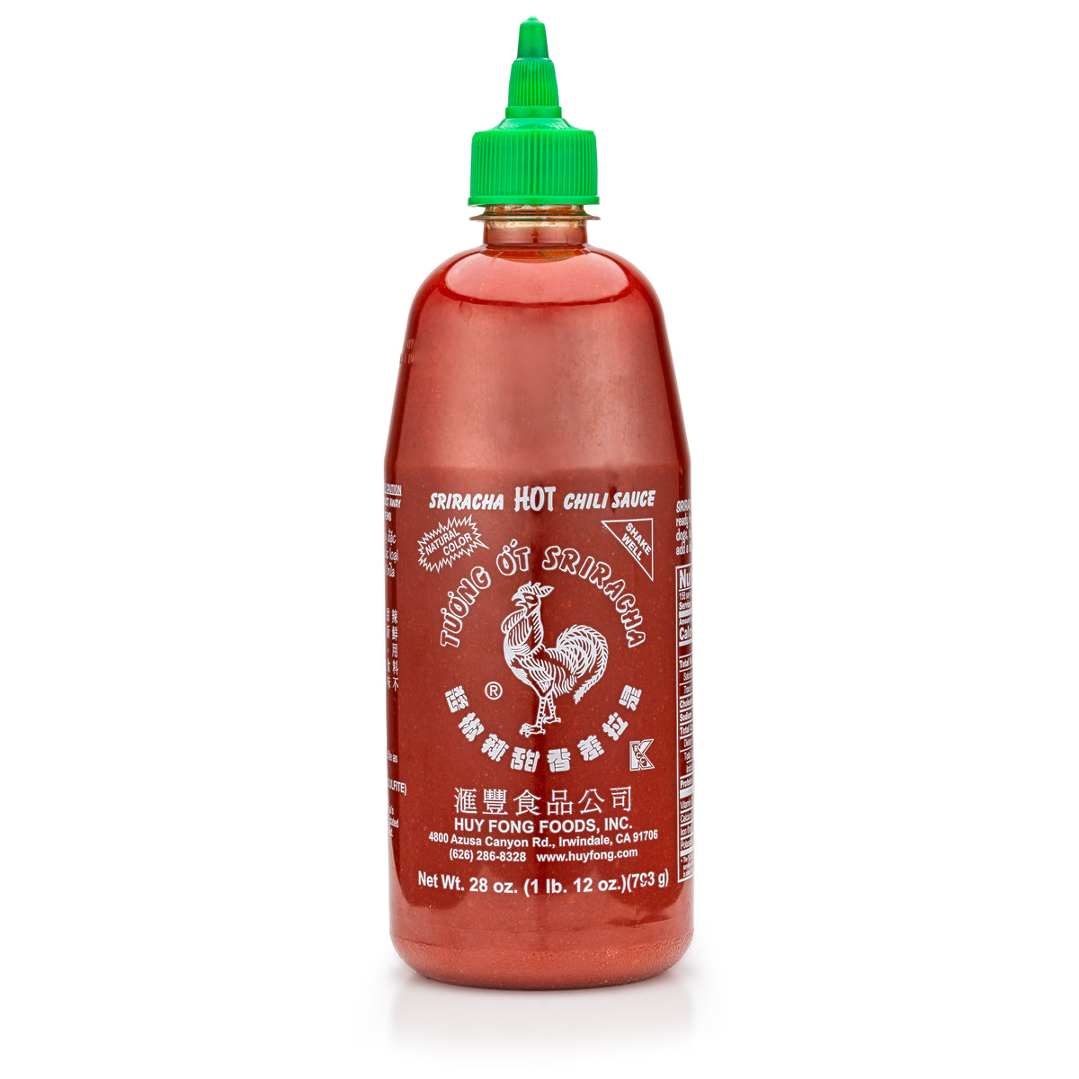 Bottle of Sriracha hot chili sauce with a green cap on a white background