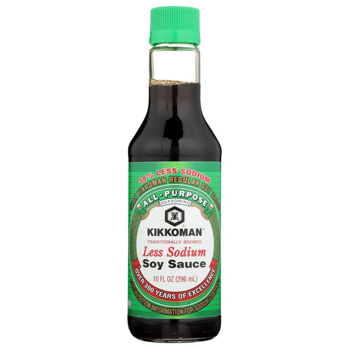 A bottle of Kikkoman Less Sodium Soy Sauce with a green cap on a white background.