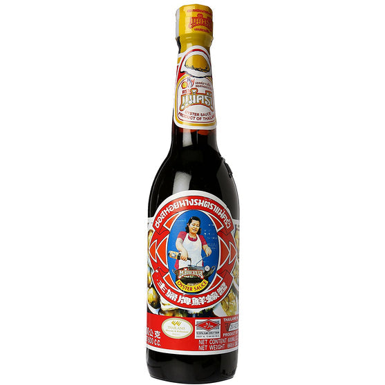 A bottle of Maekrua thai oyster sauce on a plain white background. The dark glass bottle features a colorful label with a cartoon illustration of a woman cooking in a wok with red, white, and blue text, topped with a gold cap.