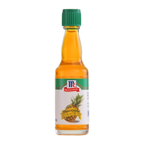 A bottle of McCormick Pineapple Flavor vinegar with amber liquid, a green cap, and a white label featuring a pineapple graphic, isolated on a white background.