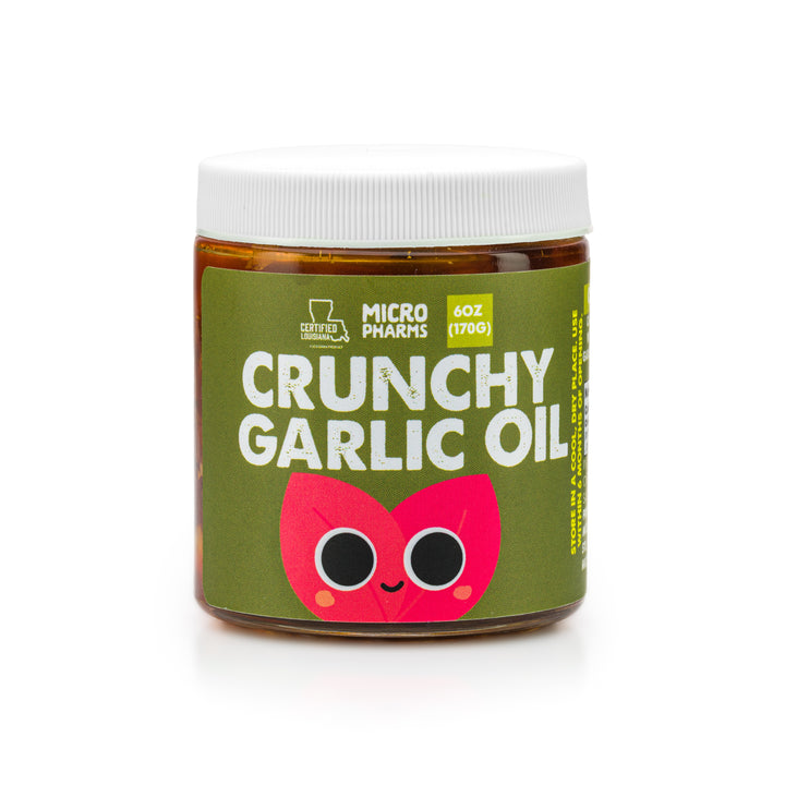A jar of Micro Pharms Crunchy Garlic Oil with a label featuring a cartoon garlic character, indicating the flavor and organic qualities of the product.