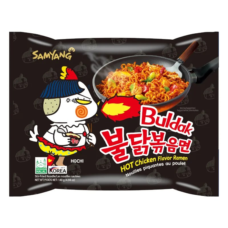 Packaging of Samyang Buldak Artificial Spicy Chicken Flavor Ramen. The package is predominantly black with a graphic of a cartoon chicken character on the front, and an image of the ramen dish with spicy sauce and sesame seeds visible.