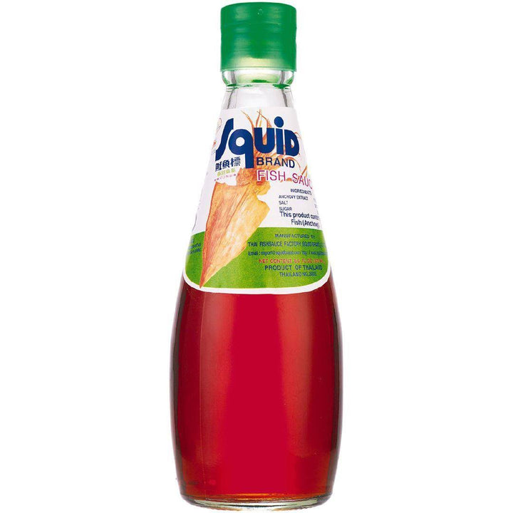 A glass bottle of Squid Brand Fish Sauce with a green cap and a label that includes the brand name and product type.
