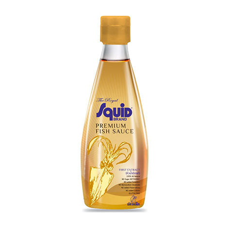 A bottle of Squid Brand Premium Fish Sauce with a golden-yellow liquid inside, a gold cap, and a blue and gold label, set against a plain white background.