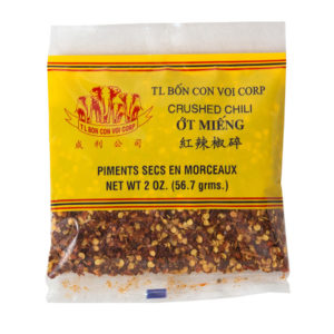 Packaged crushed chili with yellow label on a white background