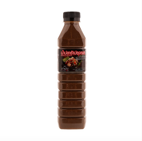 A bottle of Tummour Fermented Fish Sauce with a label showing a picture of fish and papaya, indicating the product is Thai and may be used in dishes like papaya sauce.